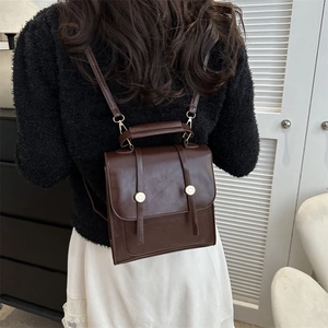 Vintage brown PU leather backpack and handbag for women shown from a back view