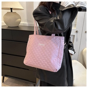 Pink quilted tote bag detail with FASHION label and long handle for shoulder carry