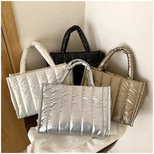 Close-up of quilted space cotton tote bags in white black gold and silver metallic finish