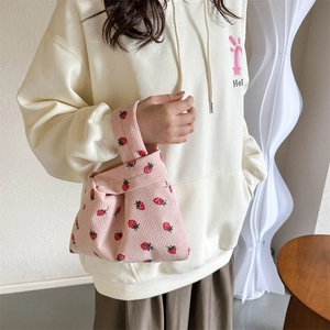 Pink corduroy tote bag with red strawberry print for trendy winter commuting