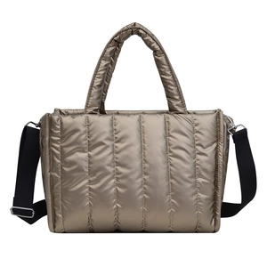 Metallic quilted crossbody tote bag in champagne gold with adjustable shoulder strap