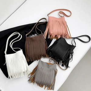 Five assorted colors of tassel bucket bags in pebble leather with bohemian fringe detail