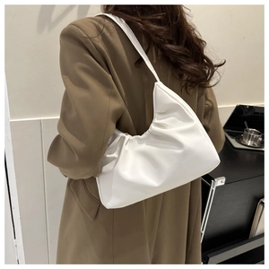 White ruched leather croissant shoulder bag styled with a professional brown suit