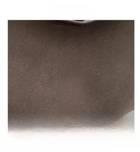 Detailed macro view showing the fine matte texture of the dark brown suede leather material