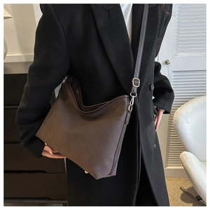 Detail view of large dark brown hobo bag with vintage matte leather and gold metal buckle