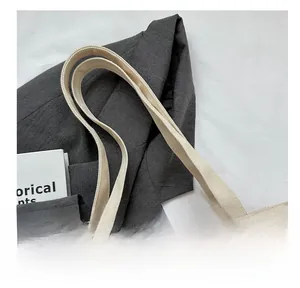 Detailed close-up of high-density thick canvas straps with solid stitching on tote bag