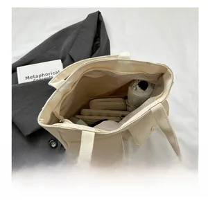Interior view of off-white canvas tote bag showing storage for umbrella and phone