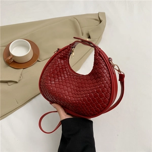 Red woven crescent shoulder bag with gold hardware and detachable strap for casual styling