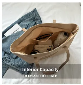 Detailed interior of the beige canvas tote bag showing large capacity and multi-pockets