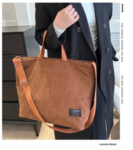 Detail of brown corduroy tote bag featuring adjustable strap and Fashion Instinct patch