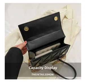 Internal view of black quilted chain bag showing space for phone and wallet