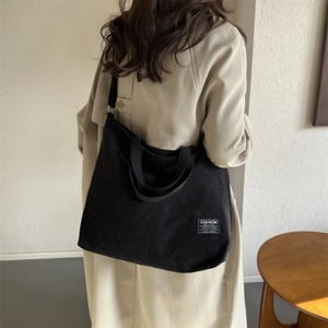 Large black corduroy tote bag for women with Fashion Instinct label and shoulder strap