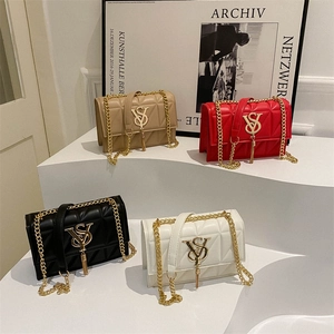 Chic quilted flap crossbody bags with chain straps in four colors on a tiered display