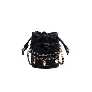Elegant black quilted bucket bag with gold heart charms and chain strap on white background