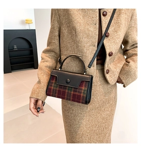 Detail of checkered tweed and black leather crossbody bag on model with tweed outfit
