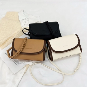 Minimalist crossbody bag with woven strap and lychee texture in three classic colors