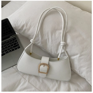 Close-up of a white PU leather shoulder bag with a gold horseshoe buckle and knotted strap