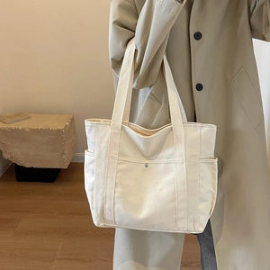 Grand sac fourre-tout en toile blanc cassé avec poches multiples au style minimaliste