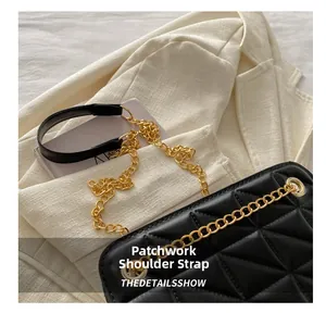 Detail showing the elegant gold metal chain and black leather shoulder strap of a quilted bag