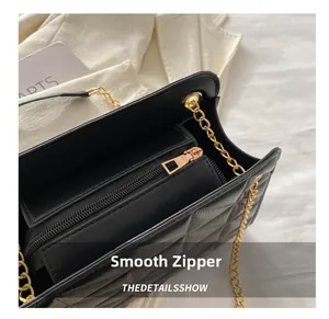 Detail shot of the smooth gold zipper and internal storage compartment of a quilted bag