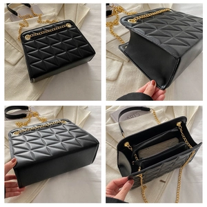 Detail view of black quilted chain bag with gold hardware and multi-angle interior compartments