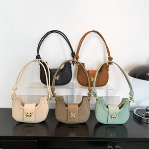 Minimalist half-moon underarm bags in five colors with golden butterfly buckles and knots