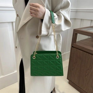 Chic green quilted shoulder bag with geometric patterns and golden chain strap