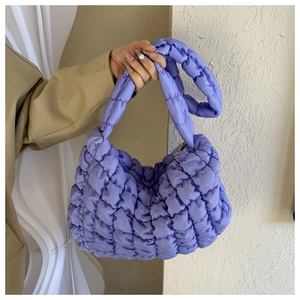 Detail of lavender quilted puffer tote bag featuring soft pleated cloud-like texture