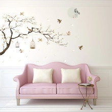 Elegant Chinese floral wall decals featuring pink blossoms and birdcages above a sofa