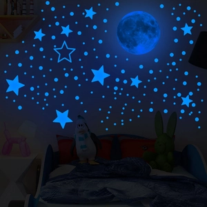 Luminous blue moon and stars wall decals glowing in a dark bedroom setting