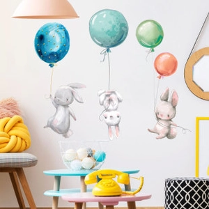 Detailed view of watercolor bunny and balloon wall decals in a cozy kids nursery room