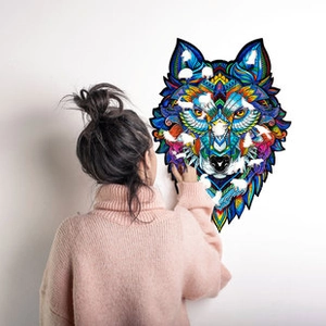 Detailed view of wolf-shaped wooden puzzle with vibrant geometric patterns on white wall