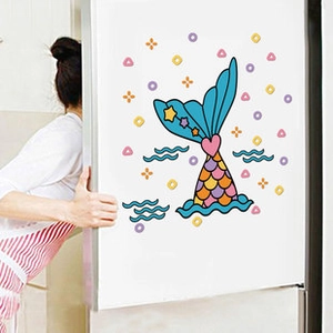 Kitchen scene showing mermaid tail wall decals applied on a white refrigerator surface