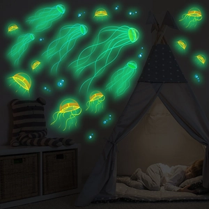 Luminous jellyfish and bubble wall stickers glowing in a dark kids bedroom with tent