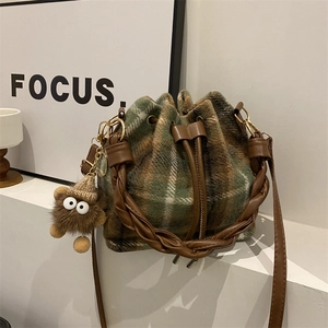 Vintage green plaid drawstring bucket bag with tweed fabric and woven handle detail