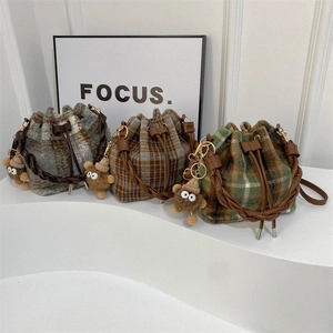 Vintage plaid drawstring bucket bag with leather handles and plush monster charms
