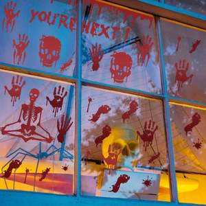 Halloween blood handprint skull stickers on window glass with You Are Next text
