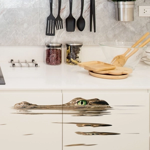 Detailed 3D wall sticker featuring a realistic crocodile eyes and texture on white cabinet
