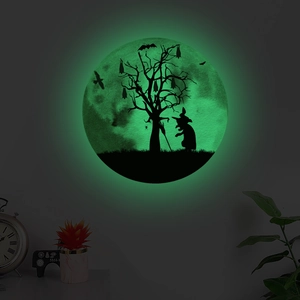 Glow-in-the-dark Halloween wall sticker featuring silhouettes of a witch, bats, and trees