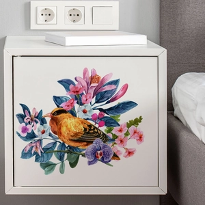 Detail view of floral and bird self-adhesive wall sticker on white cabinet surface
