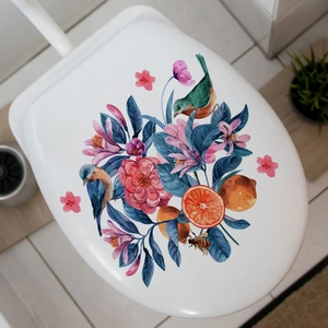 Detailed view of realistic floral and kingfisher bird stickers on a white toilet lid cover