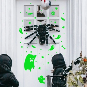 Luminous Halloween wall stickers with ghost and bat patterns on a white door