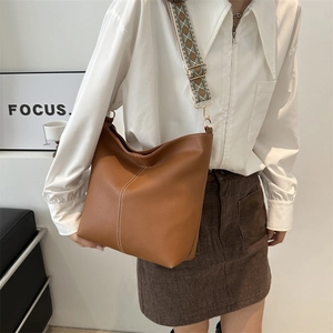 Brown litchi leather bucket bag with retro jacquard wide strap and white stitching detail