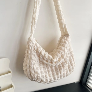 Close-up of white bubble texture fabric on a cloud hobo bag with zip closure