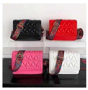 Detailed display of quilted crossbody bags in four colors with ethnic woven wide straps