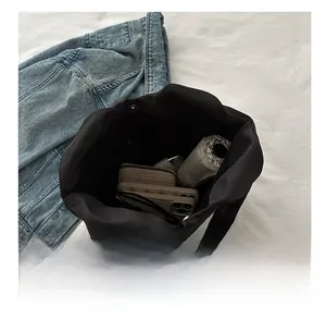 Vue intérieure du cabas noir montrant l'espace pour portefeuille, téléphone et parapluie