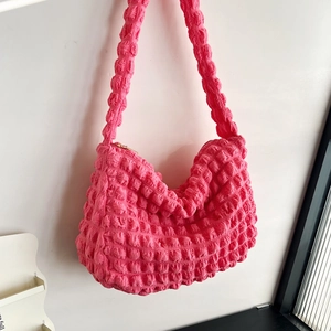 Detail of hot pink popcorn textured fabric and metal zipper on the fashion cloud bag