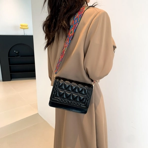 Quilted black leather crossbody bag with ethnic colorful geometric wide shoulder strap