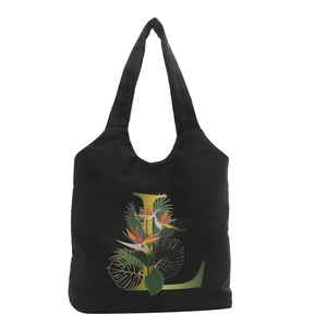 Sac fourre-tout noir en toile avec motif floral d'oiseau du paradis et lettre L dorée