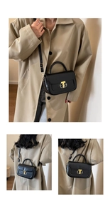 Dettaglio della borsa a mano in pelle nera con elegante chiusura in metallo dorato lucido